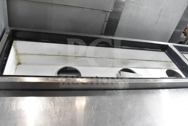 True TPP-67D-2 commercial pizza prep table with door and 2 drawers, stainless steel, 115V, visible wear inside.