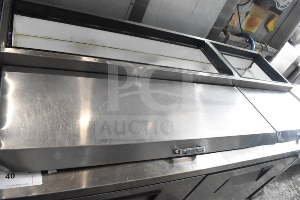 True TPP-67D-2 commercial pizza prep table with stainless steel finish, door, and 2 drawers. 115 volts, 1 phase.
