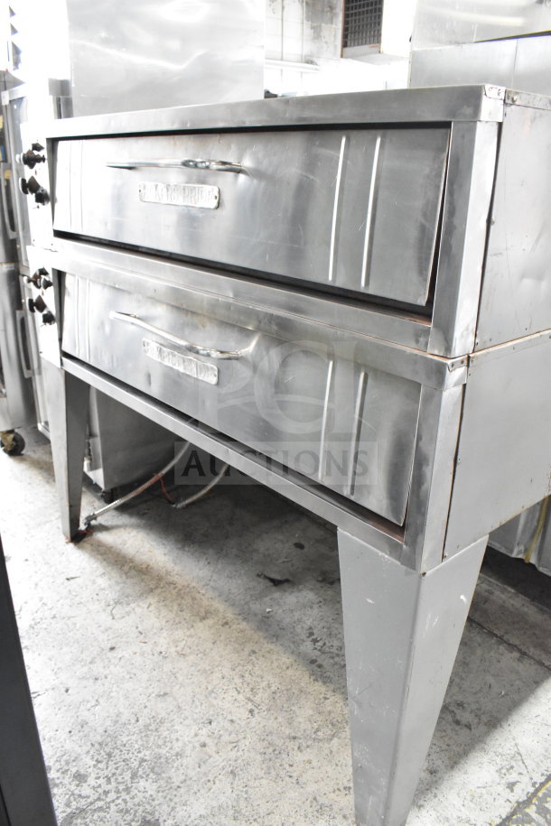 Bakers Pride E541 commercial 2-deck pizza oven on metal legs. Electric, 208V, 3-phase. Stainless steel, used condition.