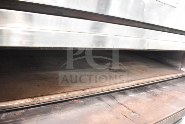 Bakers Pride E541 commercial electric 2-deck pizza oven, stainless steel, 208V, 3-phase, on metal legs. Used condition.
