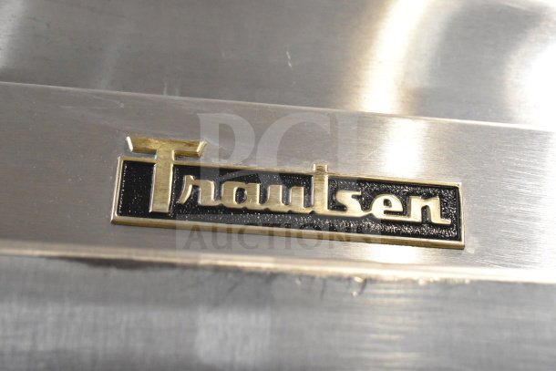 Traulsen stainless steel logo on RHT132WUT-HHG model, commercial refrigerator. Specification Line, features glass half door.