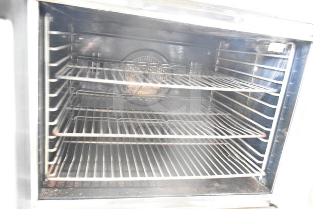 Blodgett commercial gas convection oven with view-through doors and thermostatic controls, interior shelving visible.