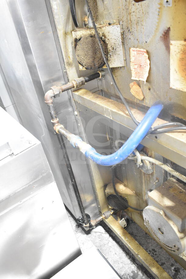Blodgett commercial gas convection oven back view, showing pipes and gas connection. View-through doors, thermostatic controls. Fair condition.