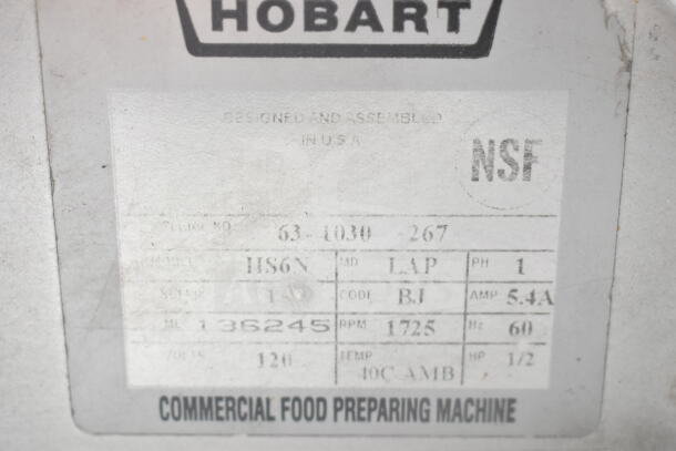 Hobart HS6N manual slicer label, showing model, serial number 136245, operates at 120 volts, NSF certified.