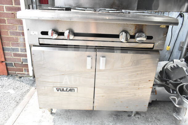 Vulcan commercial gas 4-burner range, stainless steel, floor style, used condition, visible Vulcan branding on front.