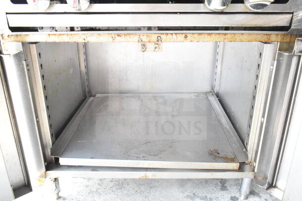 Vulcan commercial 4-burner gas range, floor style, with visible wear and rust on metal surfaces. Ideal for restaurant use.
