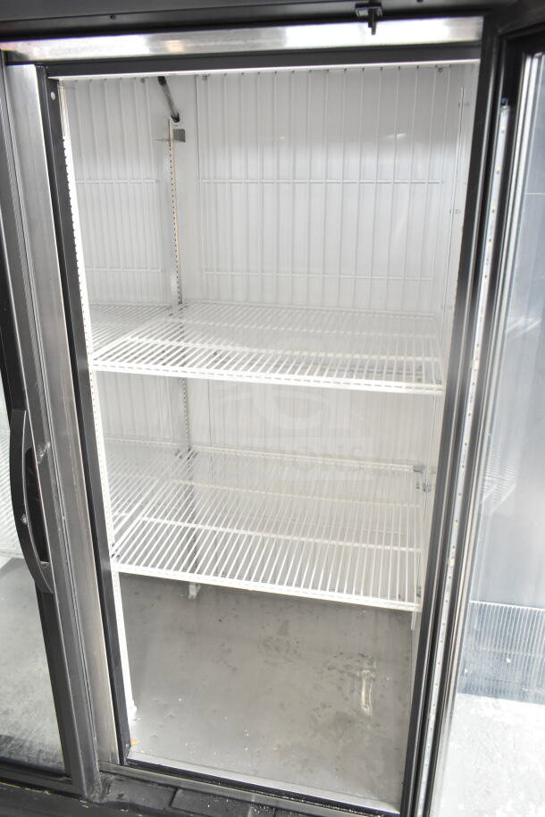 2019 True GDM-49F-HC commercial freezer with two clear doors, three wire shelves, in excellent condition. 115/208-230 volts.