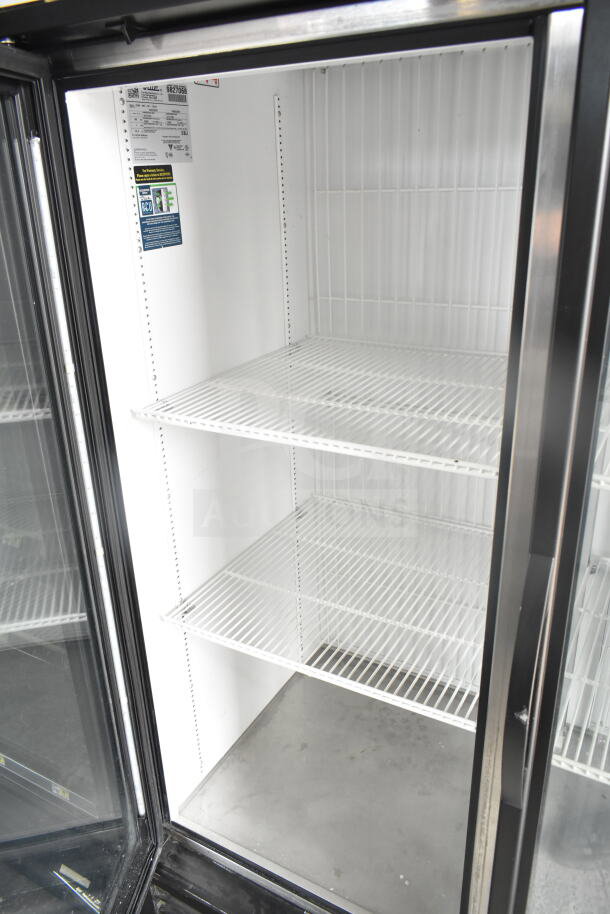 2019 True GDM-49F-HC commercial 2-door reach-in freezer, white interior, adjustable shelves, model info displayed.