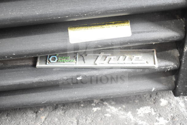 True GDM-72-HC 3-door reach-in cooler, commercial, black, "natural refrigerant" label visible. 115V, 1 phase.