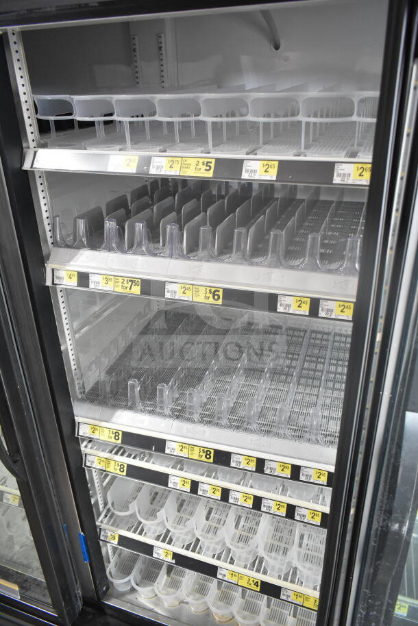 2019 True GDM-72-HC 3-door reach-in cooler merchandiser, shelves with price tags, 115 volts, 1 phase.