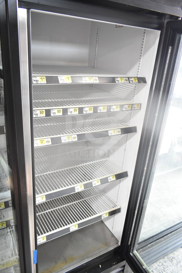 2019 True GDM-72-HC commercial cooler, 3 glass doors, multiple shelves, 115 volts, good condition, price labels visible.