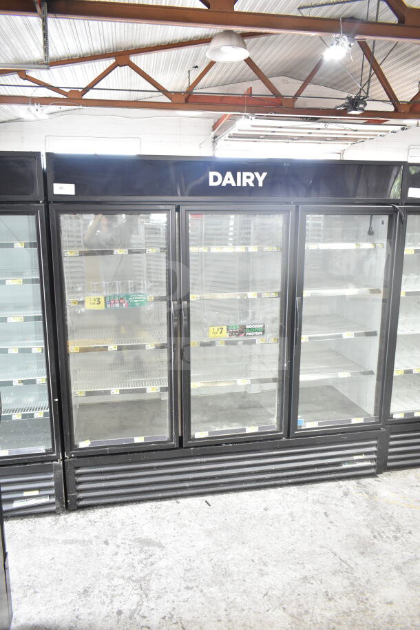 2019 True GDM-72-HC commercial 3-door cooler merchandiser. Glass doors, labeled "Dairy," good condition. 115V, 1 Phase.