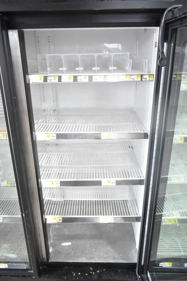 2019 True GDM-72-HC commercial cooler with three glass doors, adjustable shelves, and visible pricing labels. 115 volts, 1 phase.