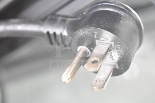 Close-up of the 115V power plug for a 2019 True GDM-72-HC commercial 3 door cooler merchandiser.
