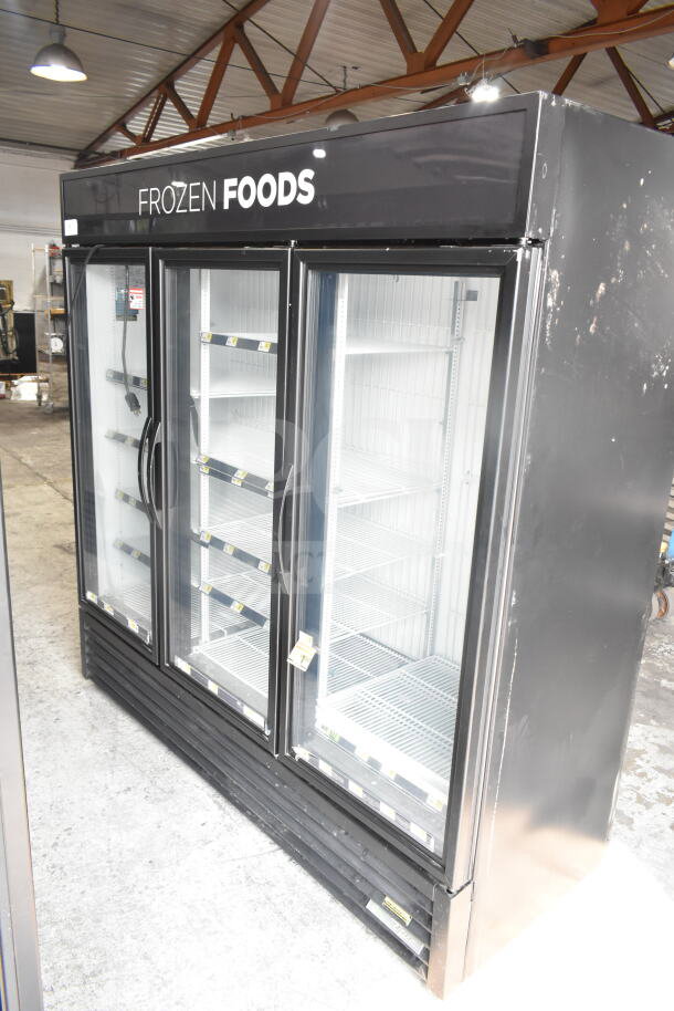 2019 True GDM-72F-HC 3 Door Reach In Freezer Merchandiser, good condition, black exterior, “FROZEN FOODS” display.