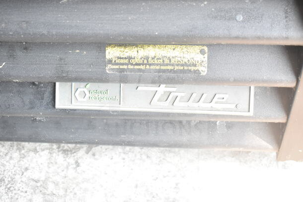 2019 True GDM-72F-HC commercial freezer, 3 doors, natural refrigerant label, True brand logo, scratches visible.