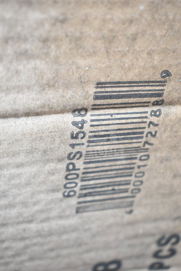 Close-up of a cardboard box with barcode "600PS1548" visible, likely part of auction lot with scratch and dent items.