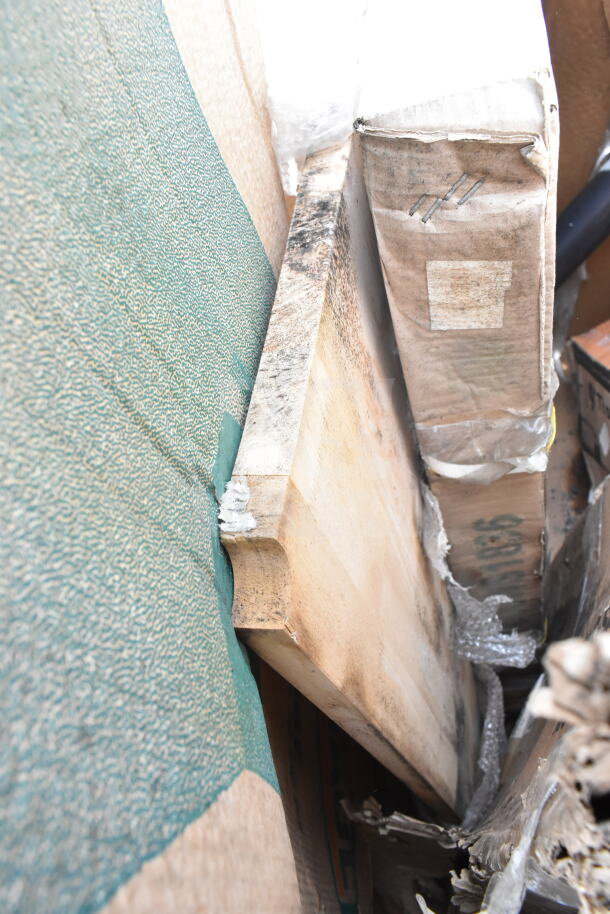 Nine brand new scratch and dent items including shelf, pot rack, and grease trap in packaging, visible wear on edges.