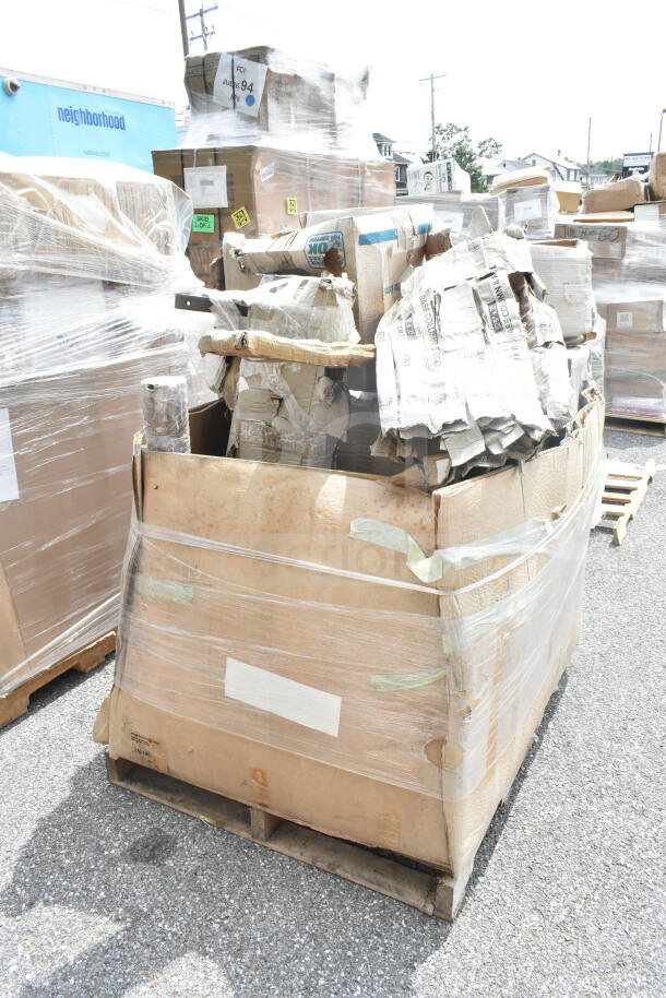 Large lot of new scratch and dent items on a pallet, including a shelf, pot rack, and grease trap. Wrapped in plastic.