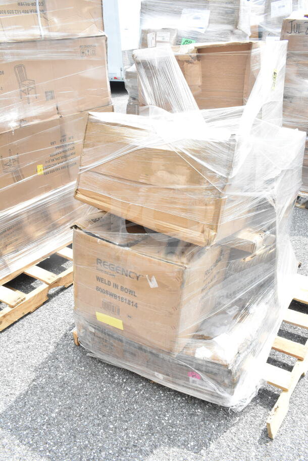 Shrink-wrapped pallet with boxes marked "Regency Weld In Bowl," indicating sink contents, showing packaging wear.