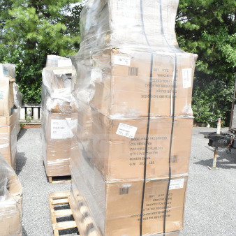 Stack of new scratch and dent items, including chairs and stools, wrapped on a pallet, labeled for auction JUL26-94.