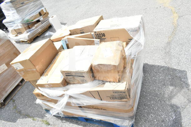 21 brand new scratch and dent items, including bowls, plates, glasses, and a trash can, in sealed boxes on a pallet.