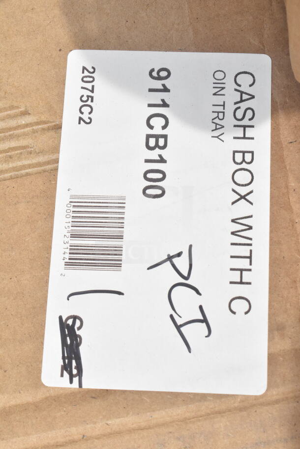 Cardboard box with label reading "Cash Box with Coin Tray, 911CB100, PCI." Visible barcode and model number.