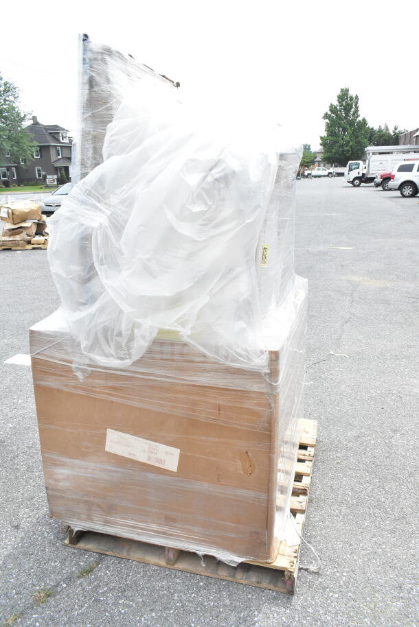 Plastic-wrapped pallet with new scratch and dent items, including a gelato pan and hotel pans. Items in boxes, minor wear visible.