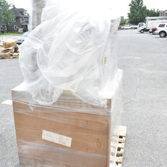 Plastic-wrapped pallet with new scratch and dent items, including a gelato pan and hotel pans. Items in boxes, minor wear visible.
