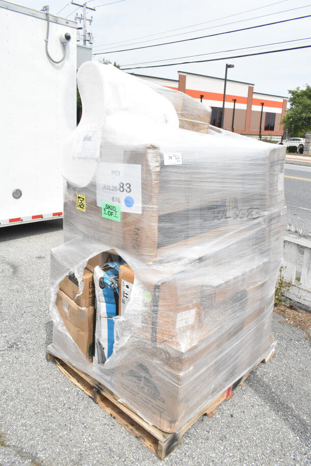 Shrink-wrapped pallet with various boxed items, labeled "JUL26-83" and "SKID 1 OF 5," including chair cushions and pendant lights.