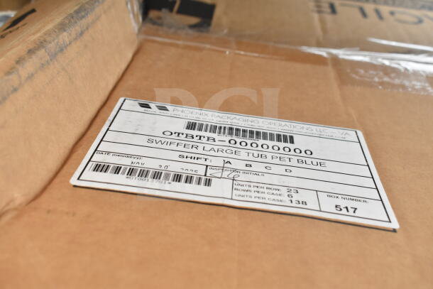 Close-up of a cardboard box with a label from Phoenix Packaging Operations. Label reads "Swiffer Large Tub Pet Blue" with box number 517.