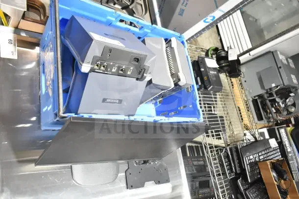 7 mixed items; includes Onn monitor, Tripp Lite bracket, Sensormatic AMB-9010-IPS. Various conditions, bulk auction.
