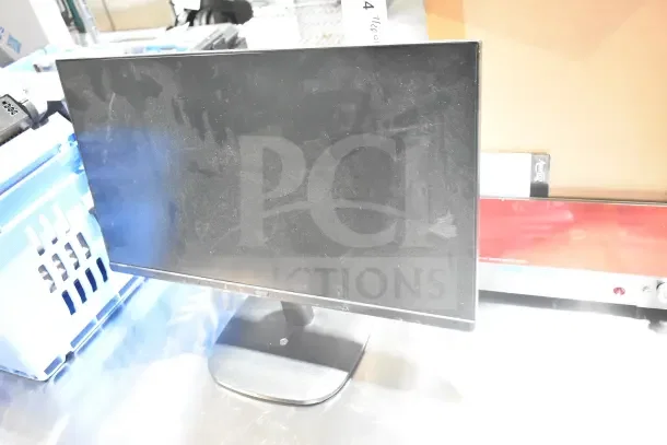 Onn Monitor with dust visible on the screen, part of a lot with Tripp Lite Bracket and Sensormatic AMB-9010-IPS. Auction item.