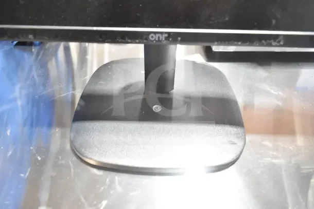 Auction lot with Onn monitor base, displaying brand name. Monitor included in a set of 7 assorted items for bidding.