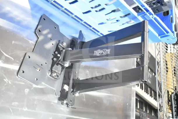 Tripp Lite bracket on metallic surface; part of a lot with Onn monitor, Sensormatic AMB-9010-IPS. Logo visible.