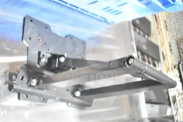 Tripp Lite bracket in metal with mounting bolts, part of a lot including Onn monitor and Sensormatic AMB-9010-IPS.
