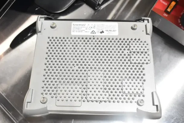 Sensormatic AMB-9010-IPS with textured base and visible label. Includes Onn monitor and Tripp Lite bracket in auction.