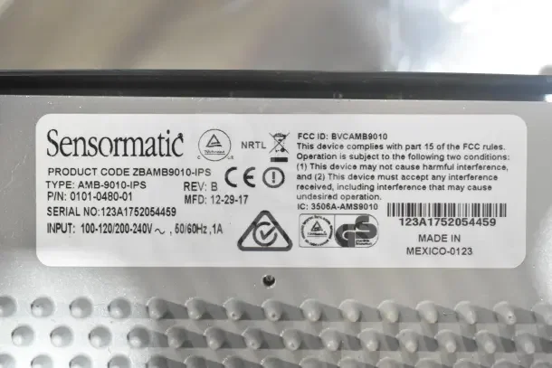 Sensormatic AMB-9010-IPS label with product code, serial number, input specs, and manufacturing details.