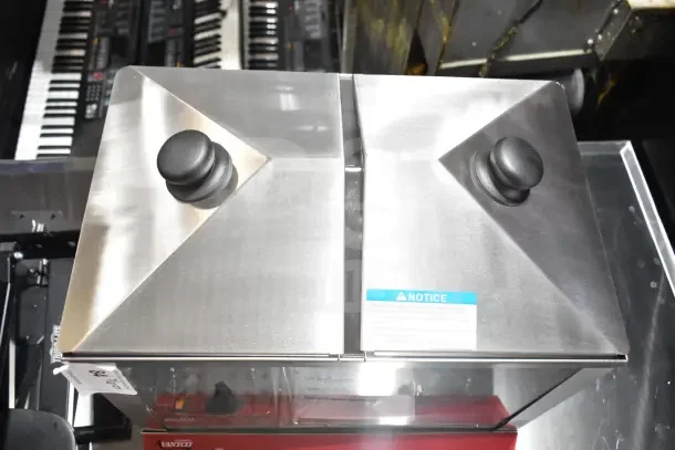 Brand new Avantco 177HDS200 hot dog steamer, 120V, holds 200 dogs, 48 buns. Stainless steel, dual lids, noticeable label.