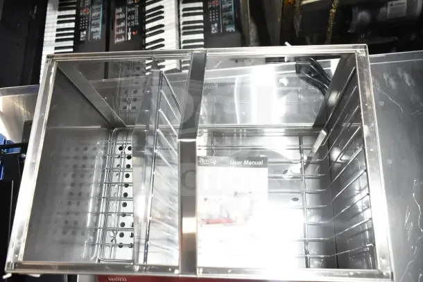 Brand new Avantco 177HDS200 hot dog steamer, visible user manual, clear compartments. Capacity: 200 dogs/48 buns.