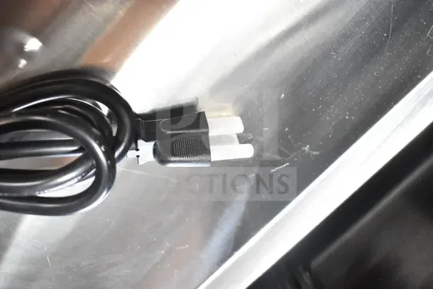 Avantco 177HDS200 hot dog steamer's power cord against metal surface; new condition despite cosmetic imperfections.