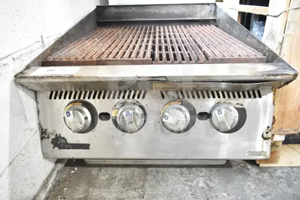 Star Commercial Countertop Gas Charbroiler Grill, used condition, four control knobs, stainless steel, model information visible.