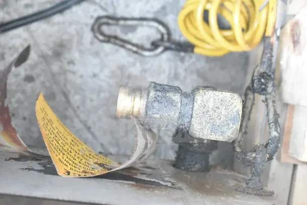 Corroded gas fitting on a Star Commercial Countertop Gas Powered Charbroiler Grill, indicating wear and maintenance needs.