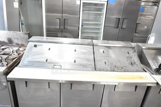 2018 True TSSU-72-30MB-ST-HC sandwich salad prep table. Stainless steel, bain marie top, on casters. 115V, 1 phase.