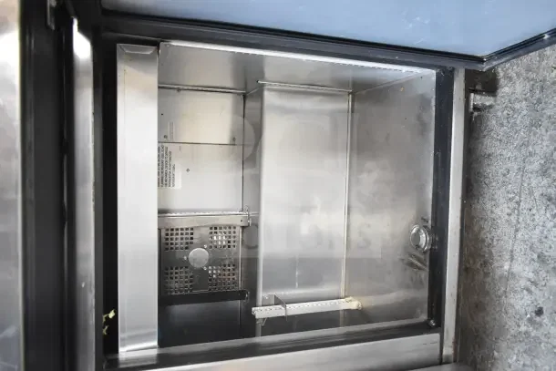 2018 True TSSU-72-30MB-ST-HC prep table, stainless steel interior, visible shelf supports, minor wear, commercial casters.