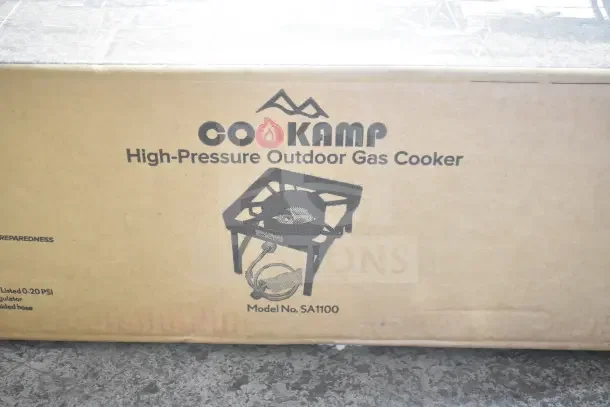 Brand new CooKamp SA1100 high-pressure outdoor gas cooker. Box displays model and includes regulator and hose details.