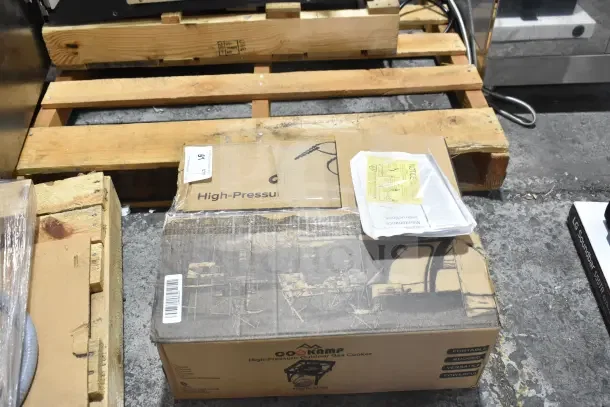 Brand new CooKamp SA1100 High Pressure Outdoor Gas Cooker in original packaging, minor scratches and dents visible on box.