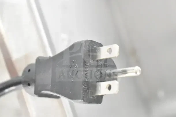 Close-up of a power plug for a 2023 Alto Shaam 200-HWI/D6, commercial hot food well. Black plug with voltage markings.