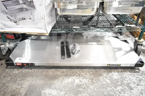 Brand new Metro HS1442 stainless steel heated shelf, 14" x 42", 120 volts, scratch and dent condition, visible Metro logo.