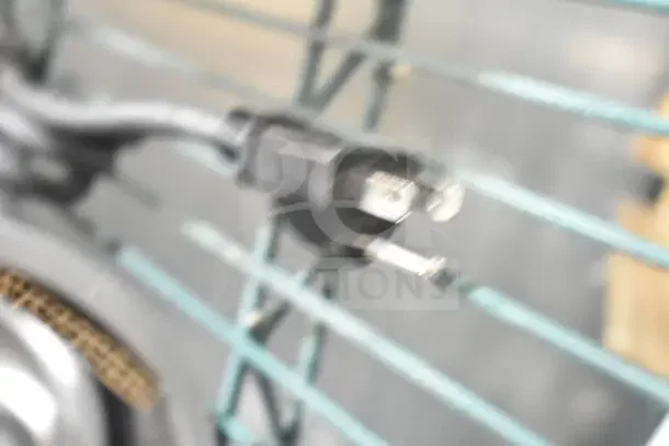Blurred image of a power plug attached to a ServIt 423BLS4 Suspension Bar Heat Lamp.
